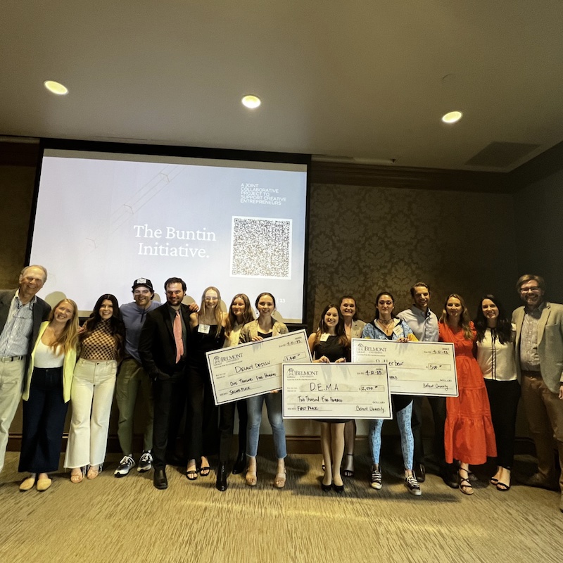 Student competitions pose with three competition finalists holding big checks