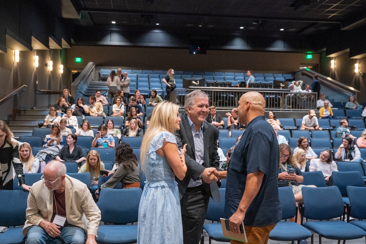 brittany schaffer and greg jones with conference attendees