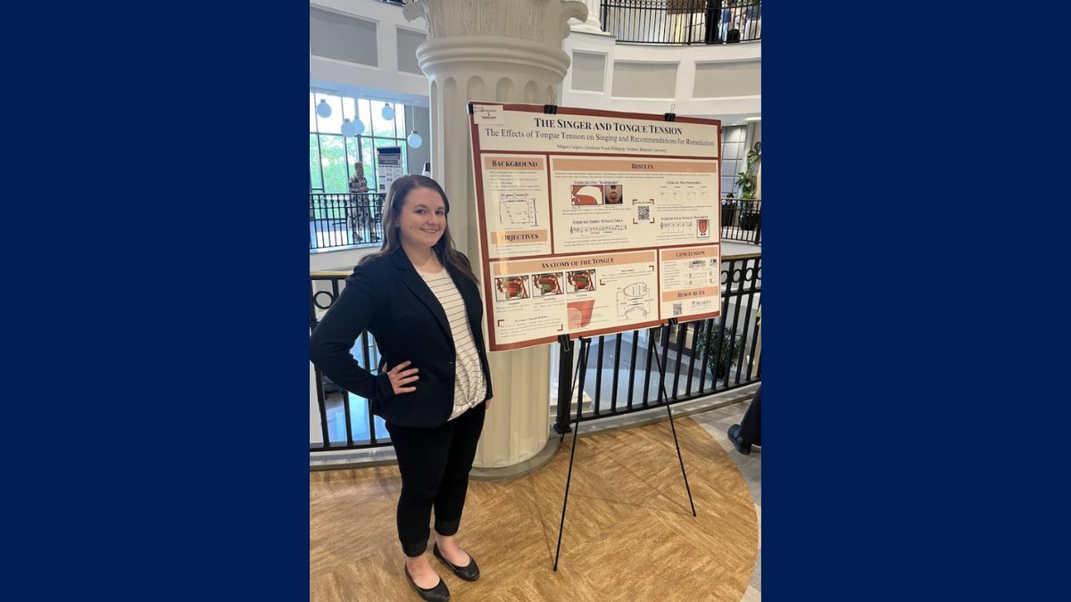 caldero stands with her research poster