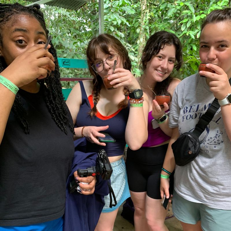Students drink sugar cane on the trip