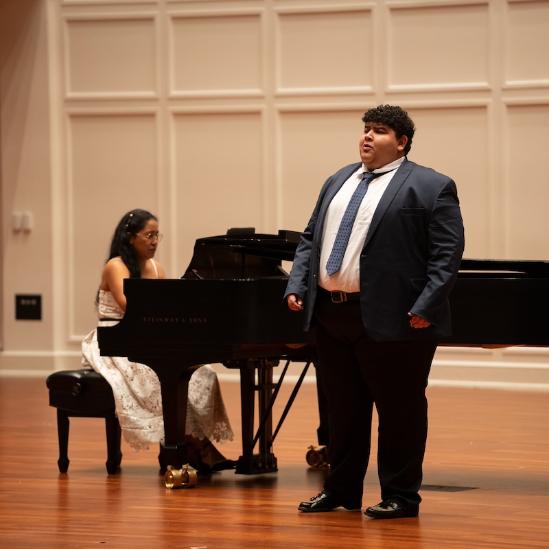 Javi Castro performing a solo with female accompanist on piano