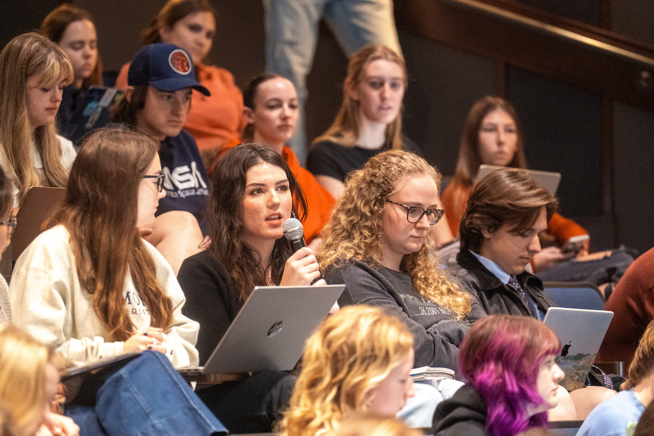 Student in crowd with microphone