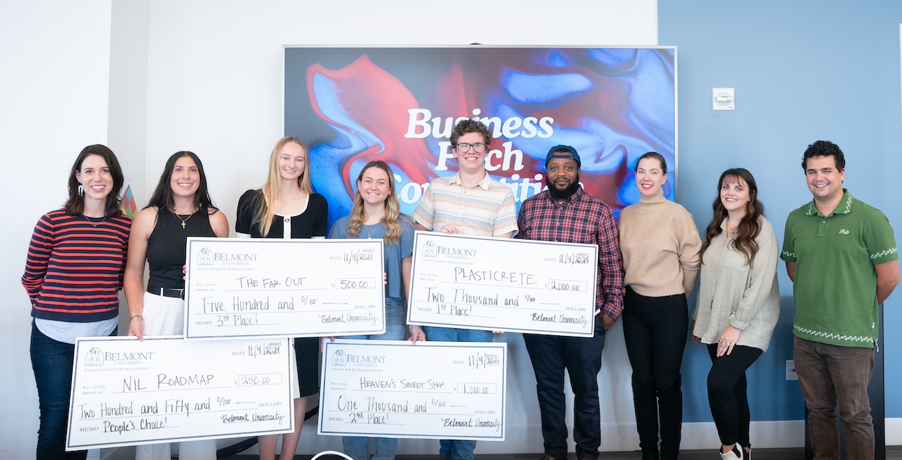 winning participants and judges posing with giant checks