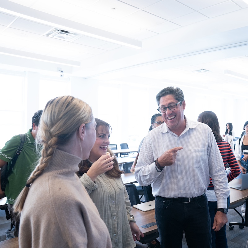 Belmont professor talking with students