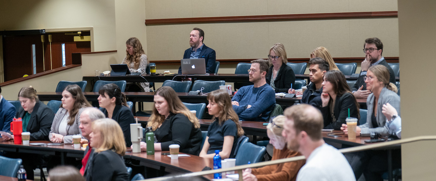 Student and faculty in law boardroom