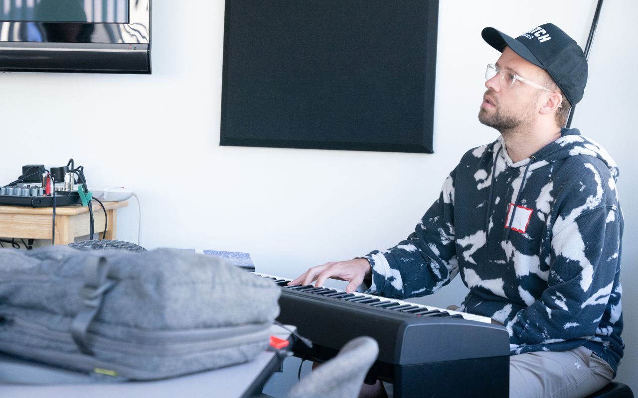 Man sits behind a keyboard