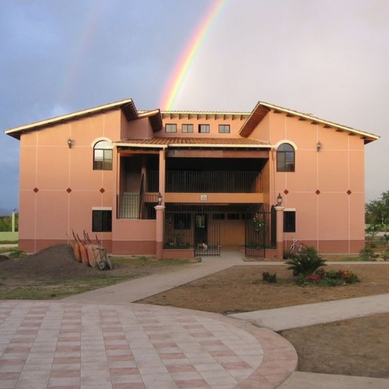 The Jovenes en Camino campus with a rainbow above