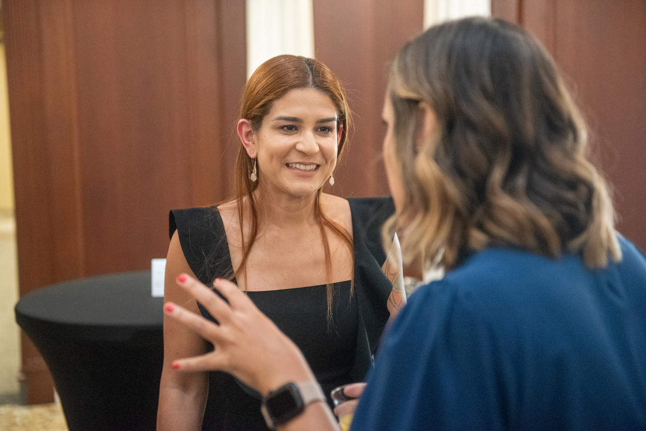 Law alumna talking with colleague