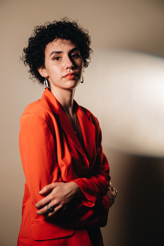 O'More alumna Marian Anderson, posed in a red blazer