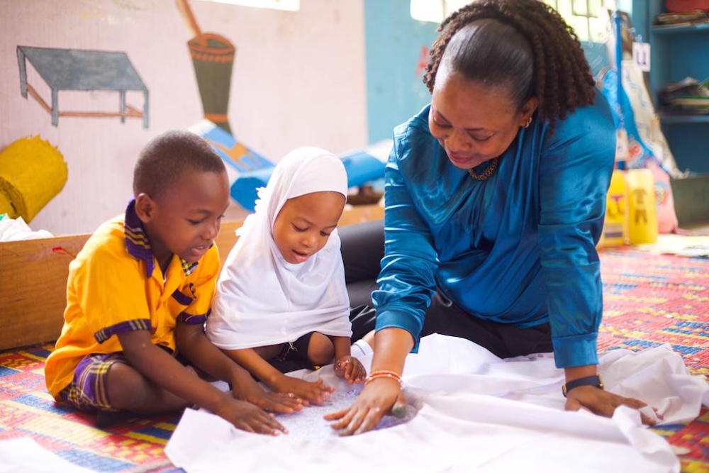 teacher at Mbande Primary School collaborates with her students