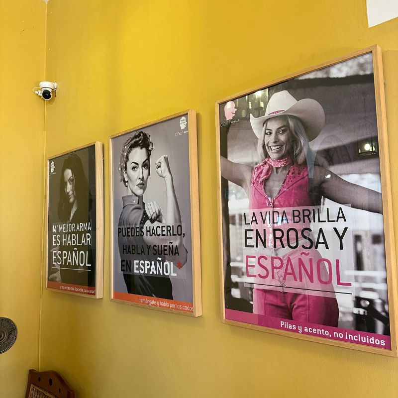 Several photos on the wall in Spanish