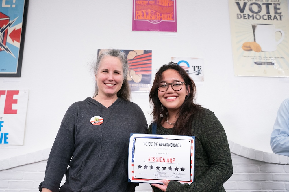 winner of part of the student poster competition holding a certificate