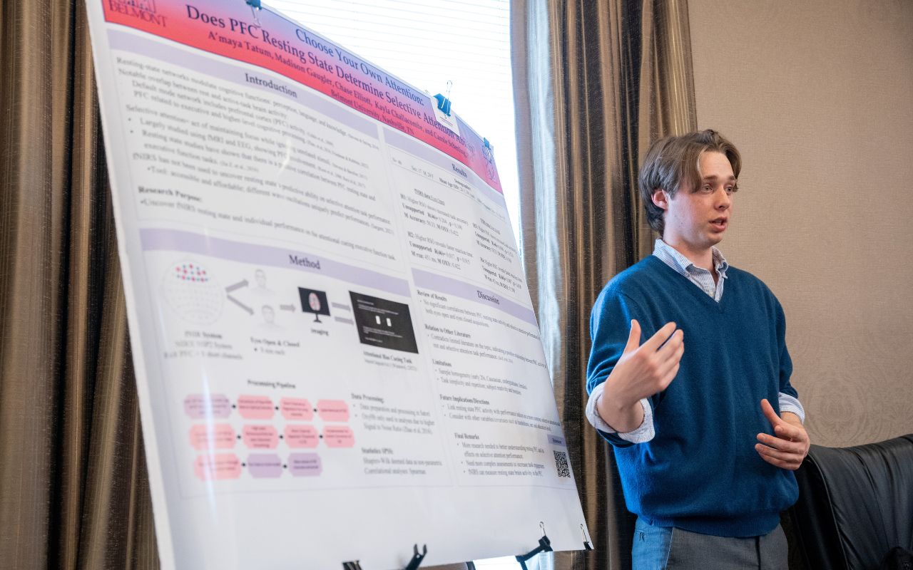 Student presents his poster