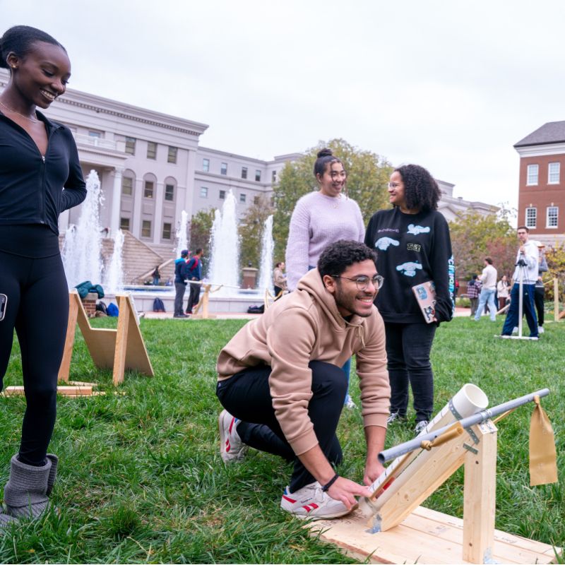 Students line up a trebuchet during a physics class at Belmont 