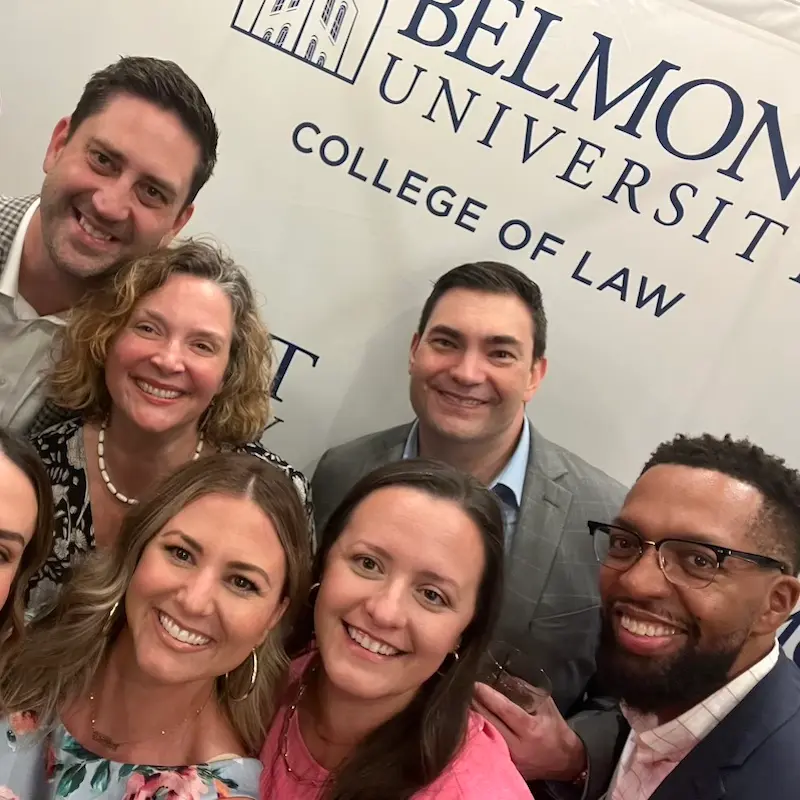 Law alumni selfie in front of step and repeat