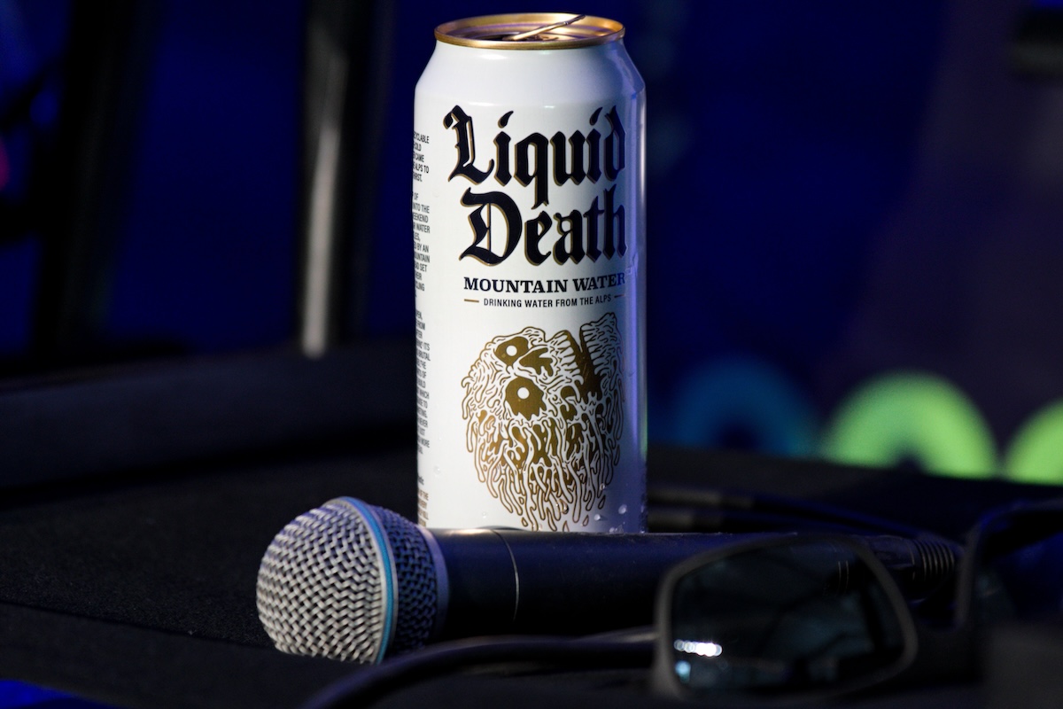 can of liquid death water and a microphone