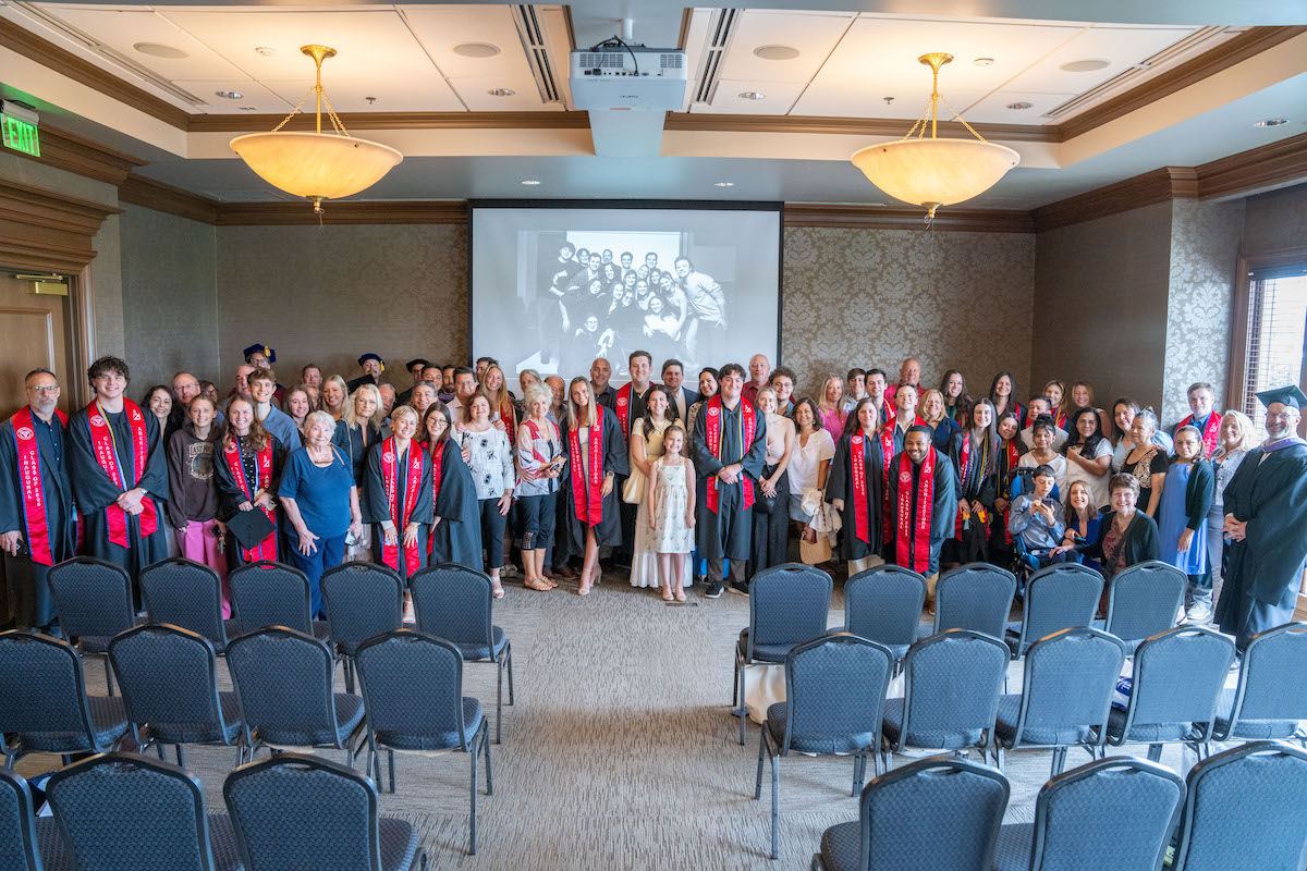 Architecture graduates and guests gather in a campus event room to celebrate Belmont’s inaugural graduating class