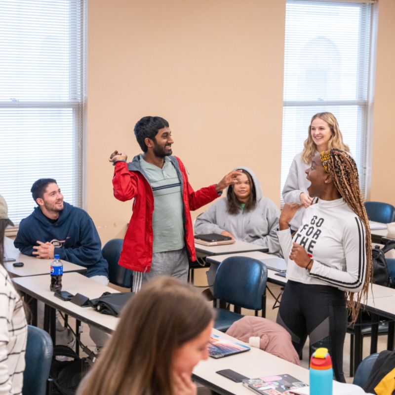 Students throw an object around the classroom