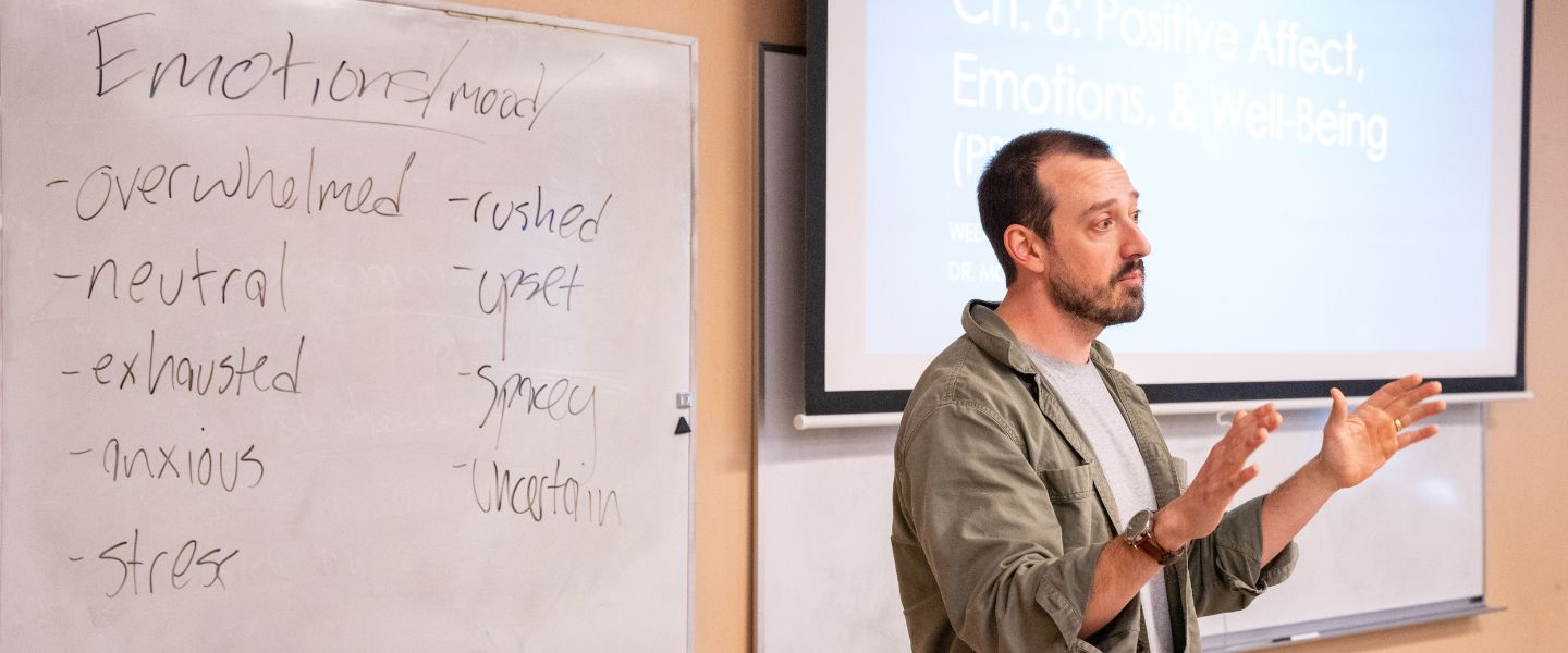 Pysch professor Dr. Patrick Morse in front of a whiteboard