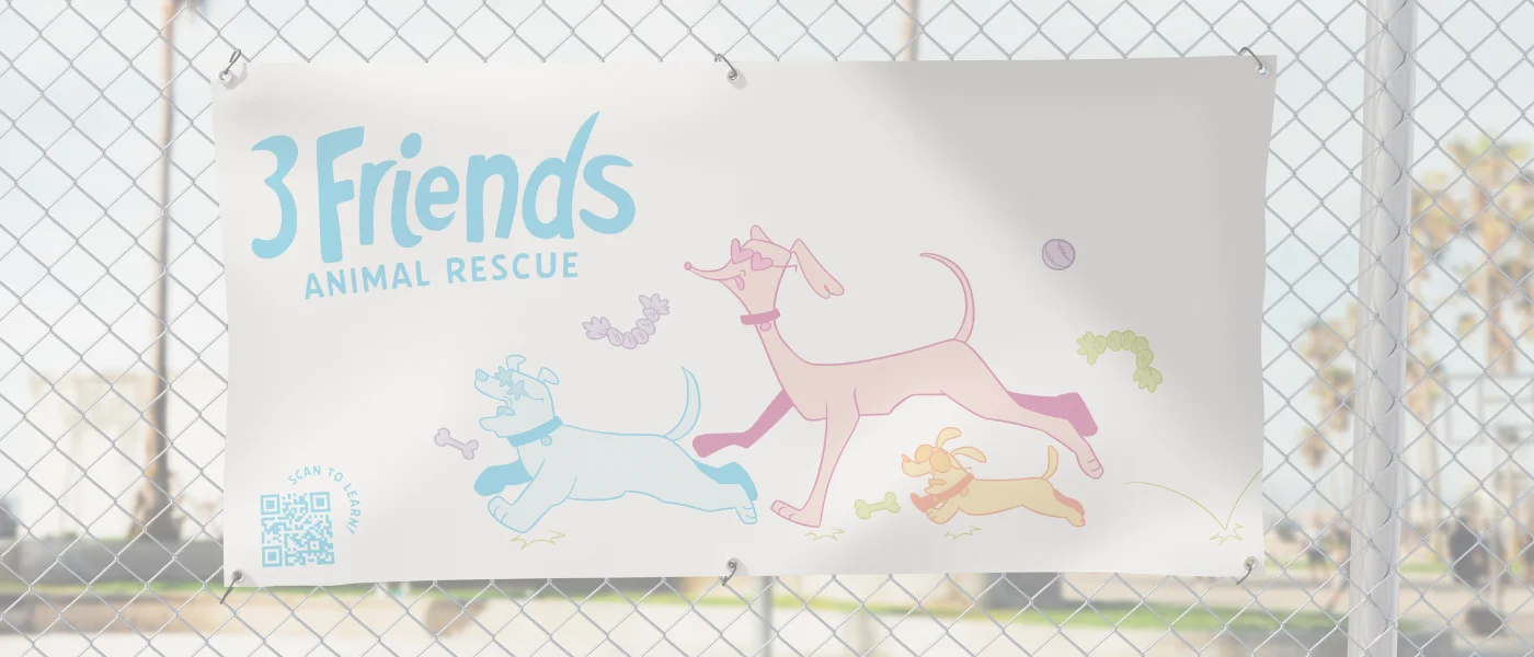 Large banner with student design hanging on a fence