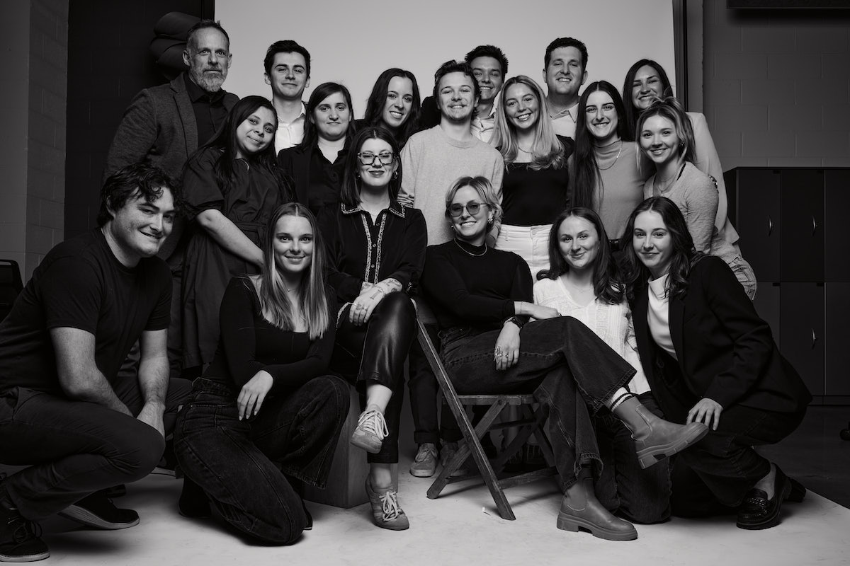 Black and white group portrait of Belmont seniors from the Class of 2025 posing together in a studio setting.