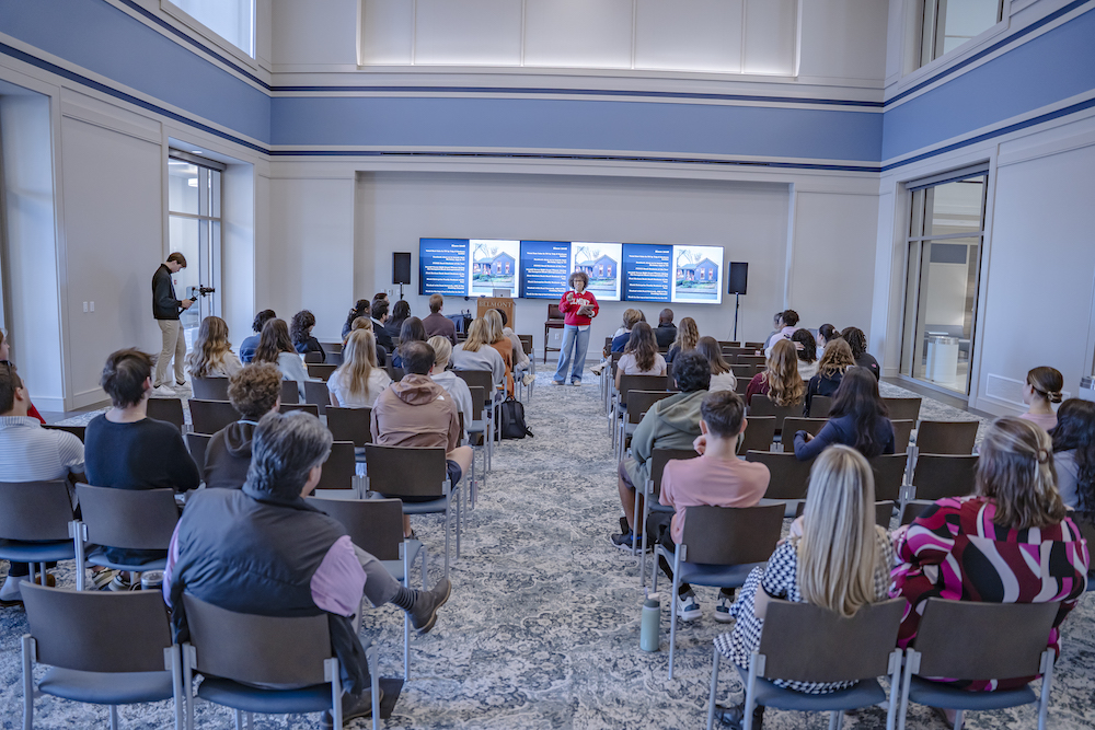 Mignon Francois speaking in front of audience