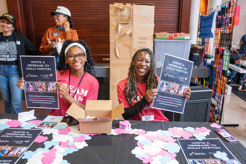 Students volunteering at Notes to Dolly Parton table