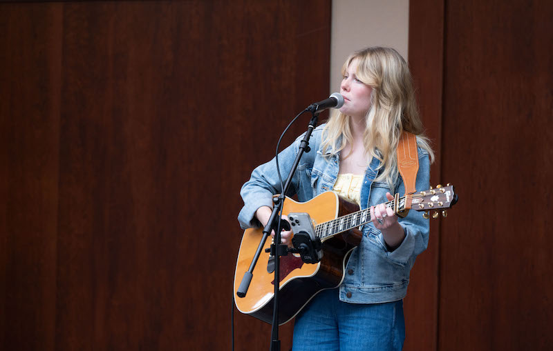 Student singing and playing guitar