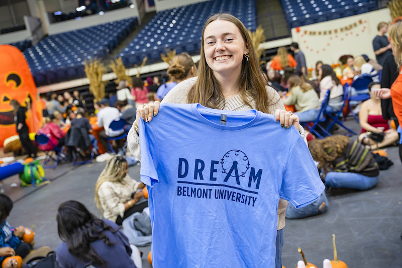 Student holding Day to Dream tshirt