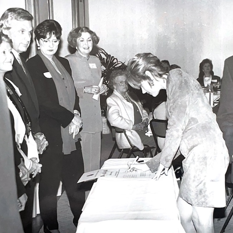 historic photo of FAB member signing a paper