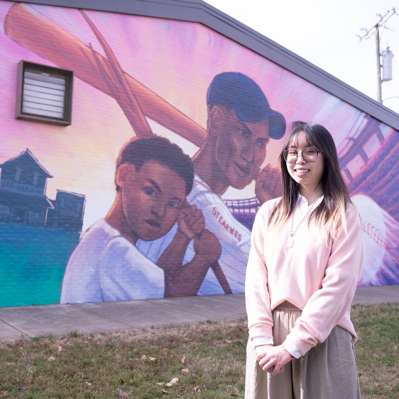 Joanna Wu with the mural
