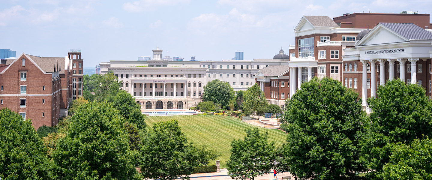Photo of campus lawn with builds and trees