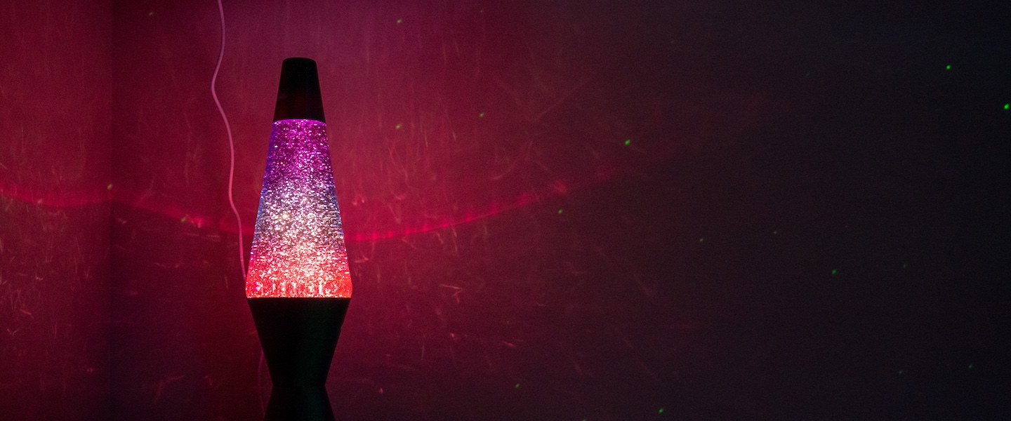 pink and purple lava lamp in a dark room