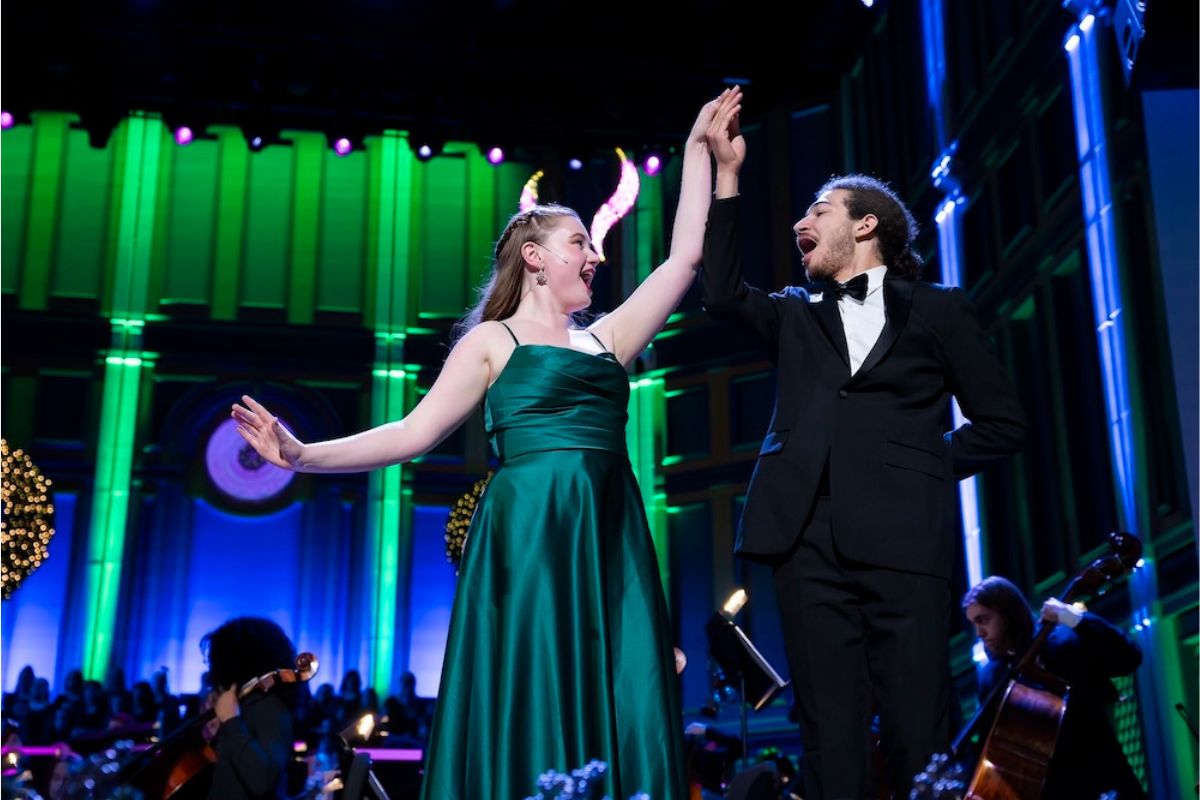 Isaac Bouldin singing and dancing on stage