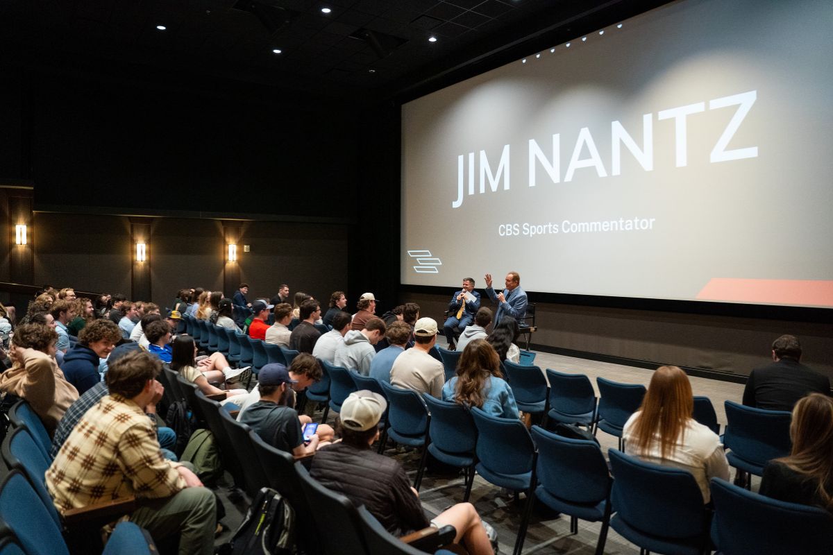 Wide angle shot of seminar room with Gregory and Nantz at the front and students sitting in a theater.