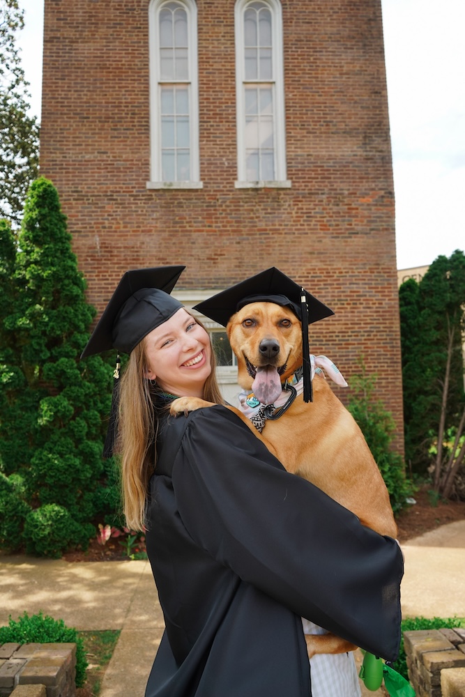 Kasey Sobek with her dog in front of the Bell Tower