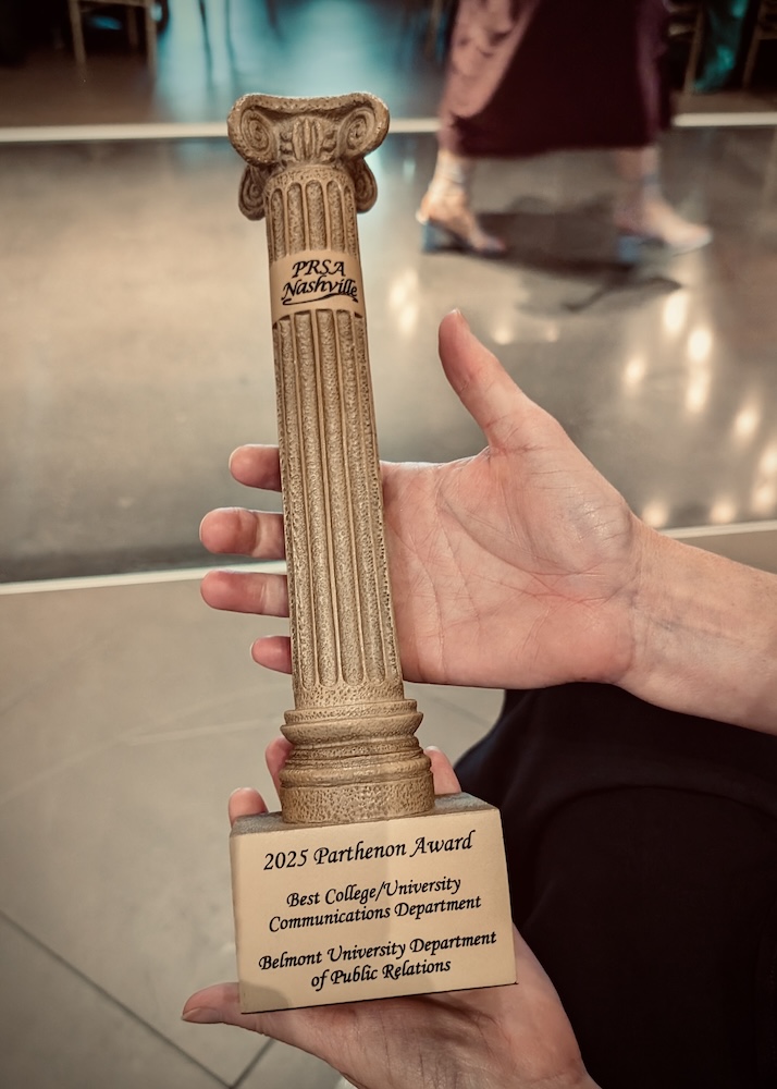 someone holding the Department's award