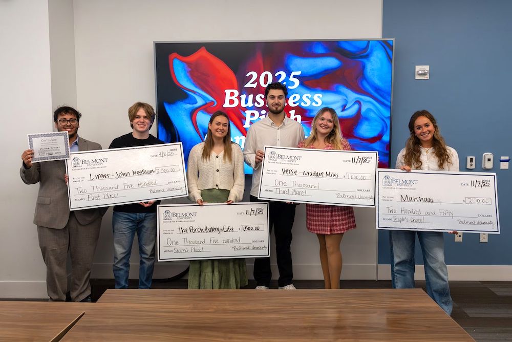 Winners of pitch competition with checks