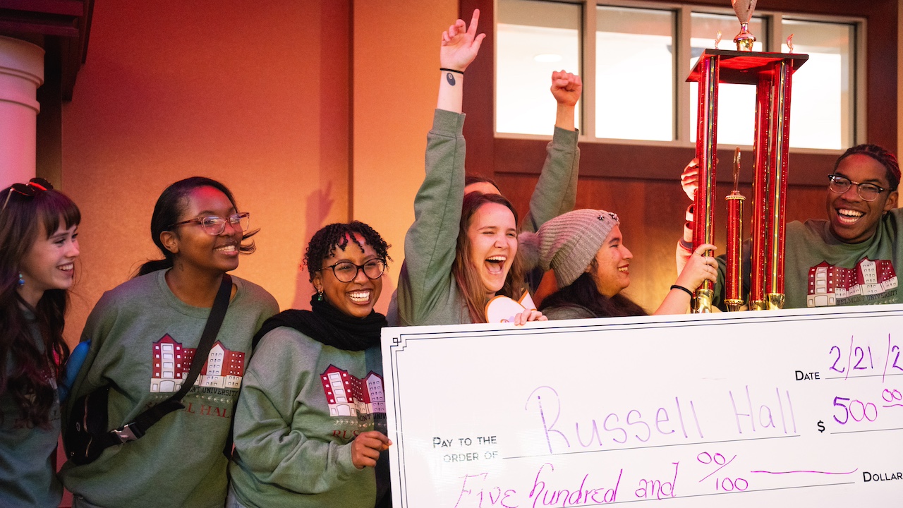 Russell hall students celebrating with giant check for $500