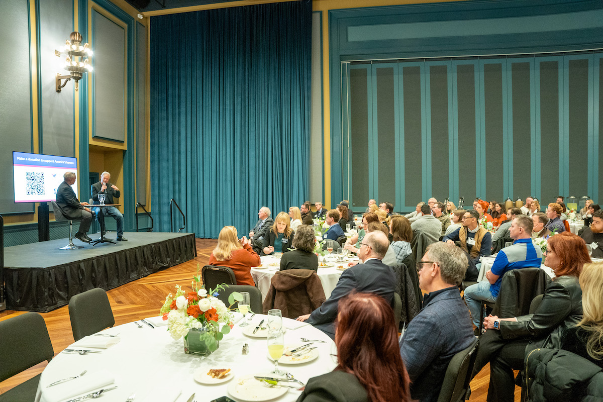 Gary Sinise speaking to luncheon attendees