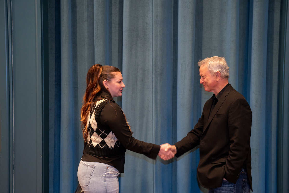 Gary Sinise shaking hands with student