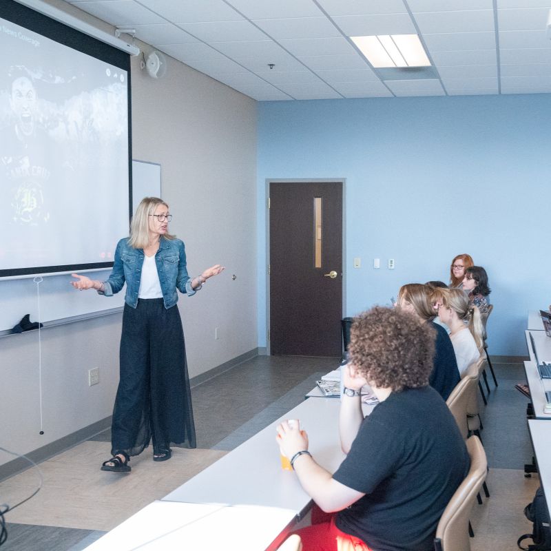 Professor stands in front of a class