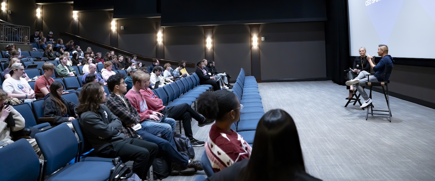 Tracy Chan and Brittany Shaffer speaking to students in a theater