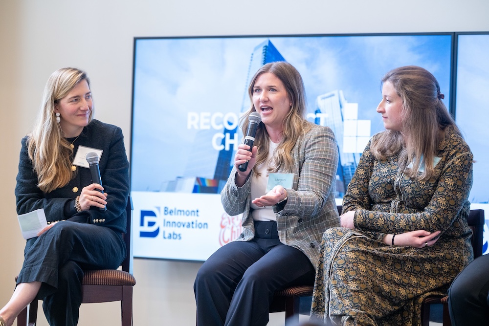 a panel speaker talks into the microphone