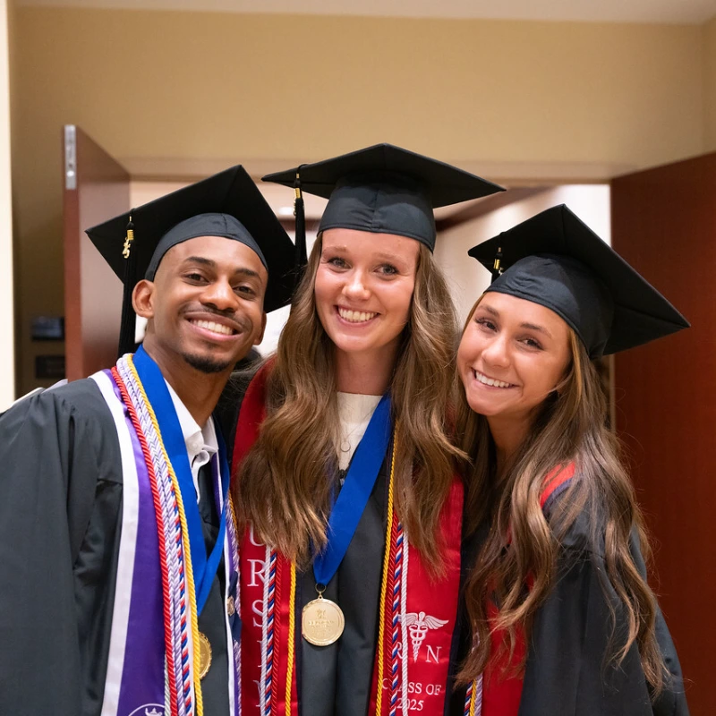 Students smiling at graduation in 2025