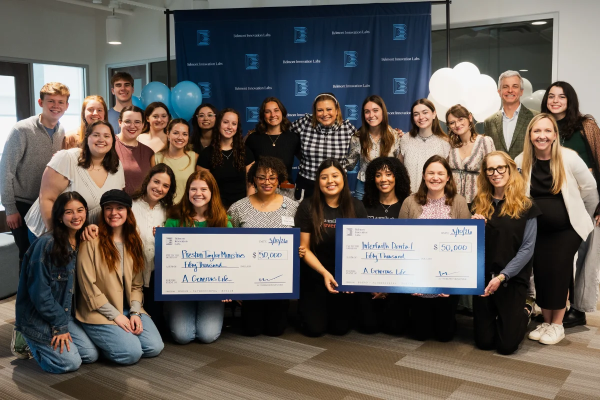 students and nonprofit reps hold giant checks