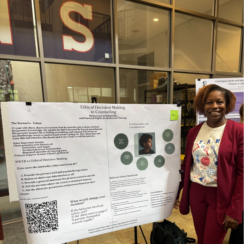 Kenya Rodriguez, standing with her presentation poster
