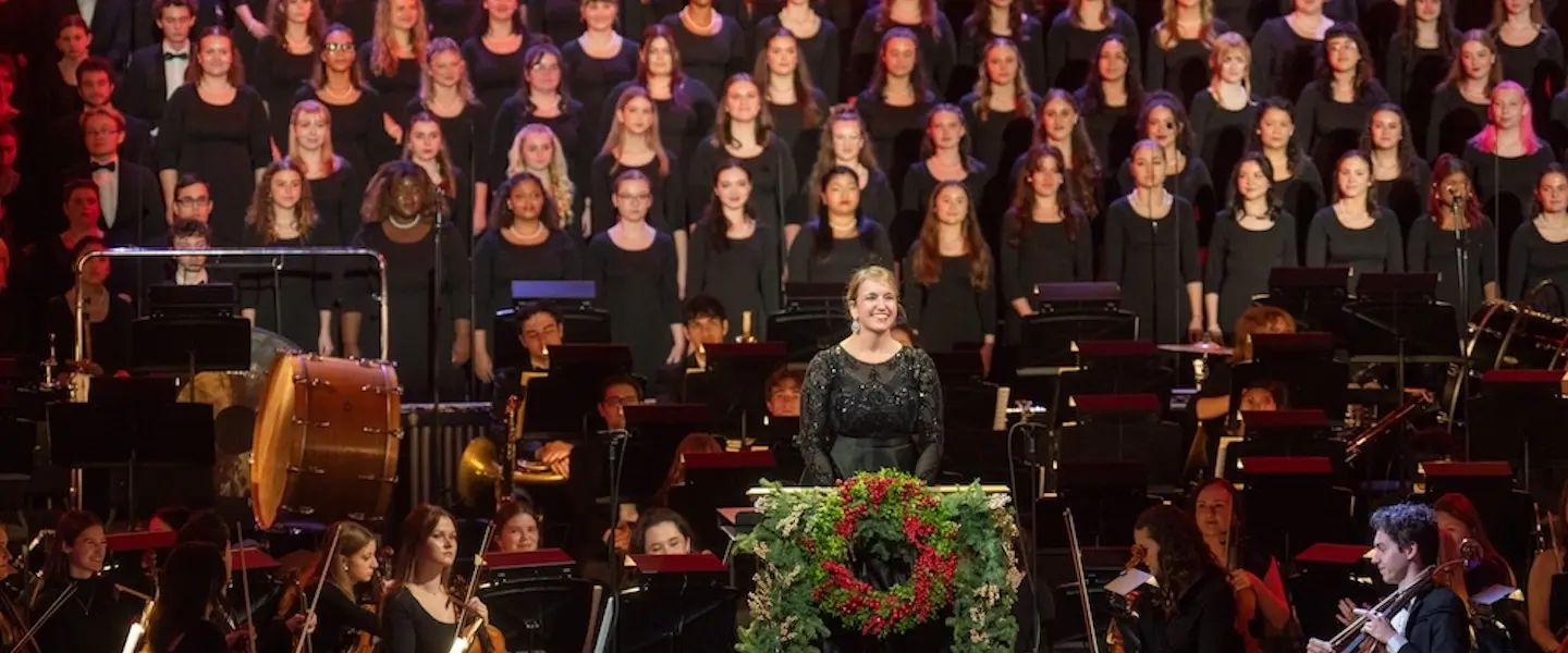 Dr. Mann smiles in front of Bel Canto performers