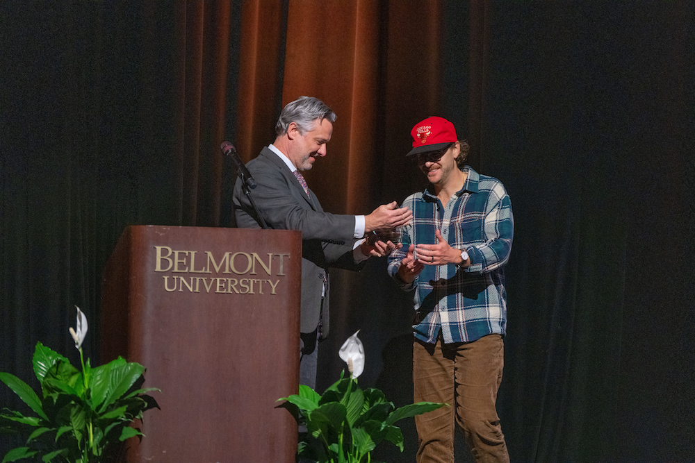 a man on stage receiving an award
