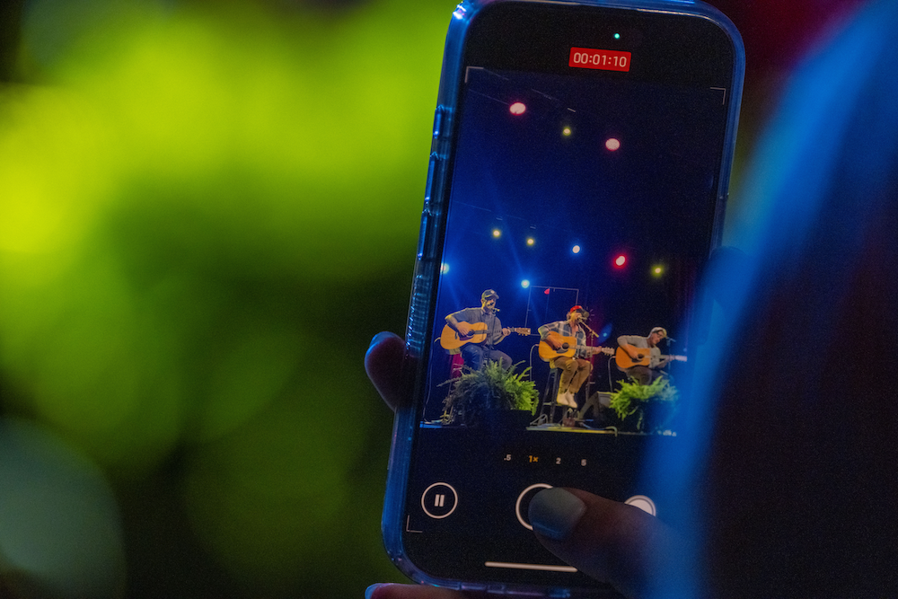 performers seen through a phone camera